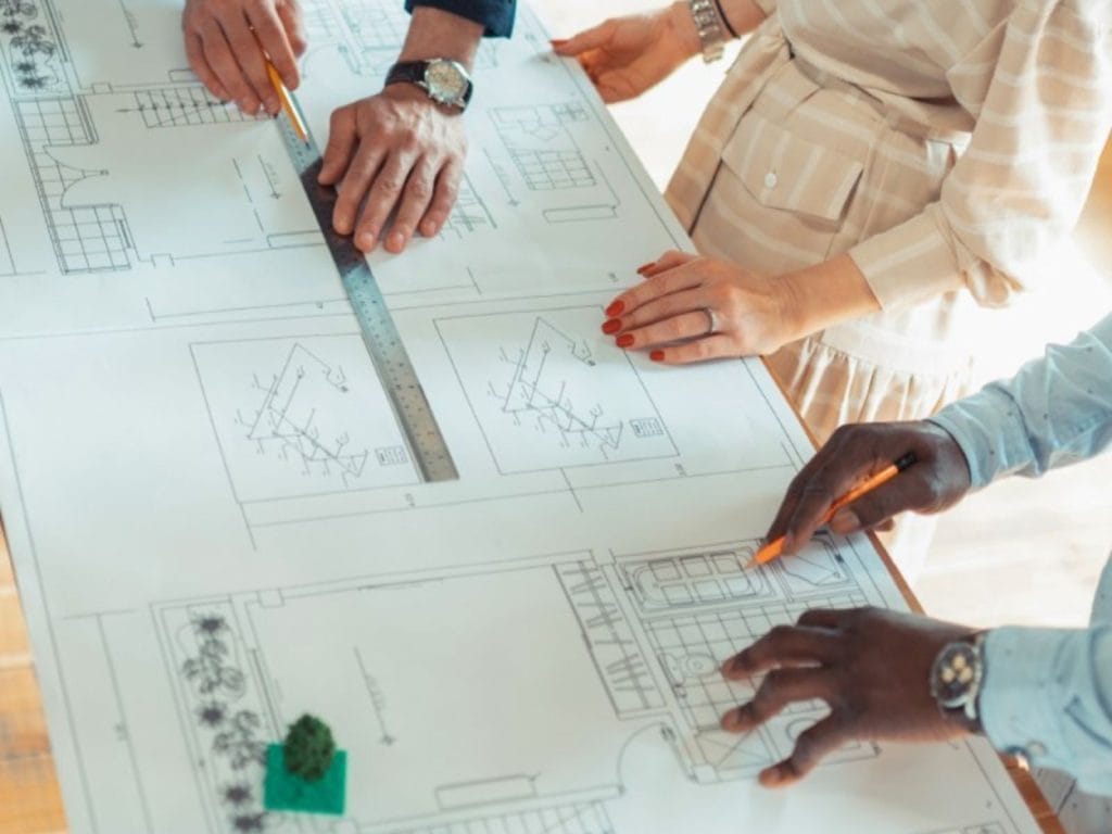 Architects and engineers designing a commercial property building plan.