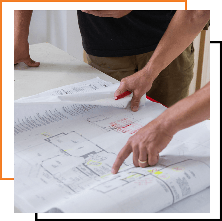 Team reviewing blueprints and schedules for effective construction planning.