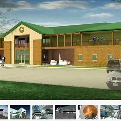 Government services building under construction with workers and equipment.